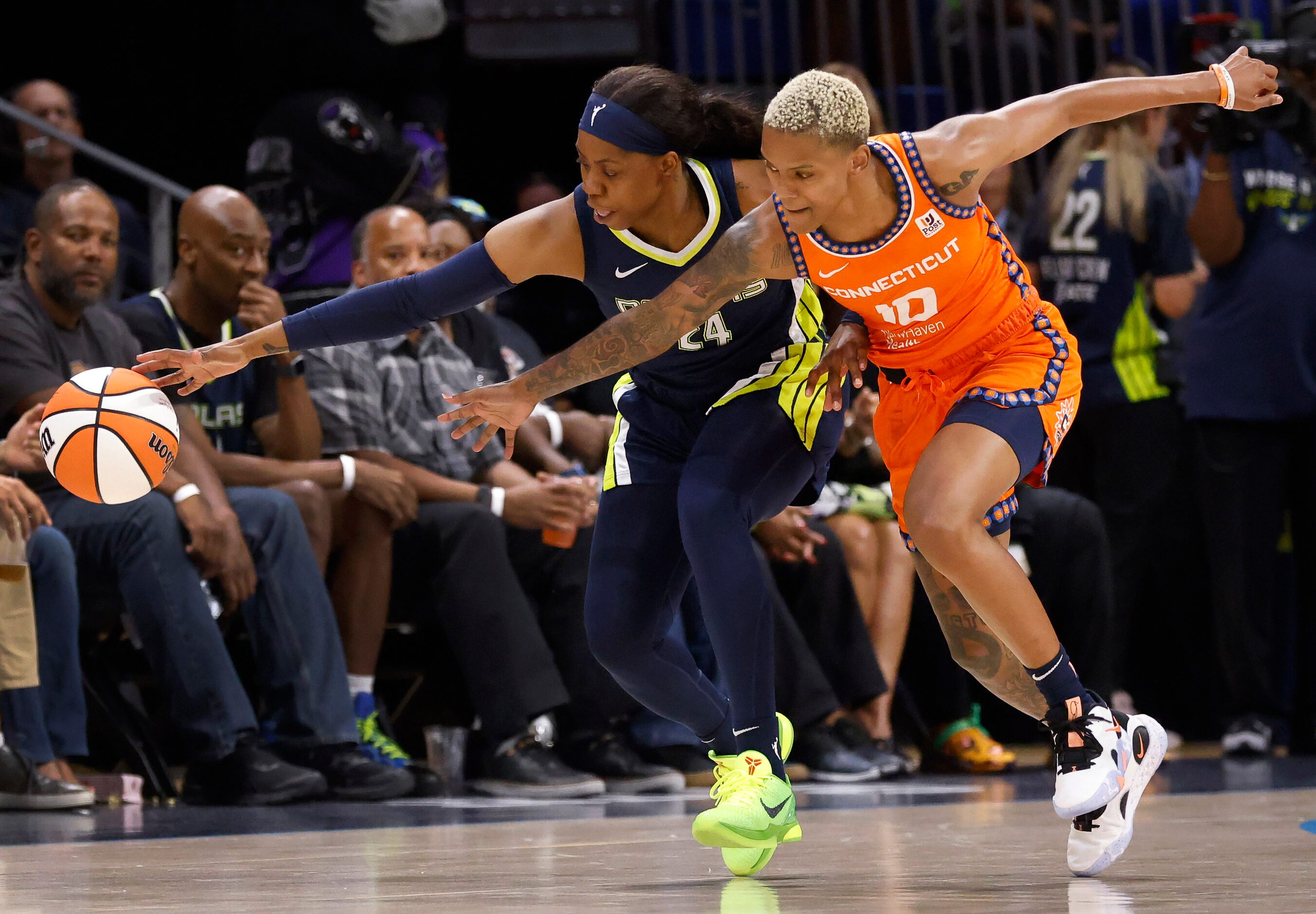 Dallas Wings guard Arike Ogunbowale (24) tries to corral the basketball from Connecticut Sun...