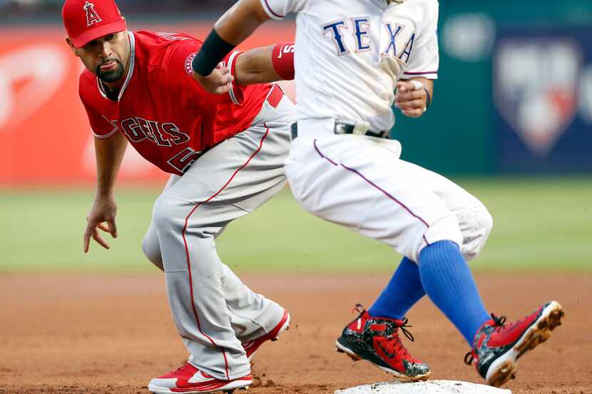 Texas Rangers second baseman Rougned Odor (12) pulls up with a leg injury before getting...