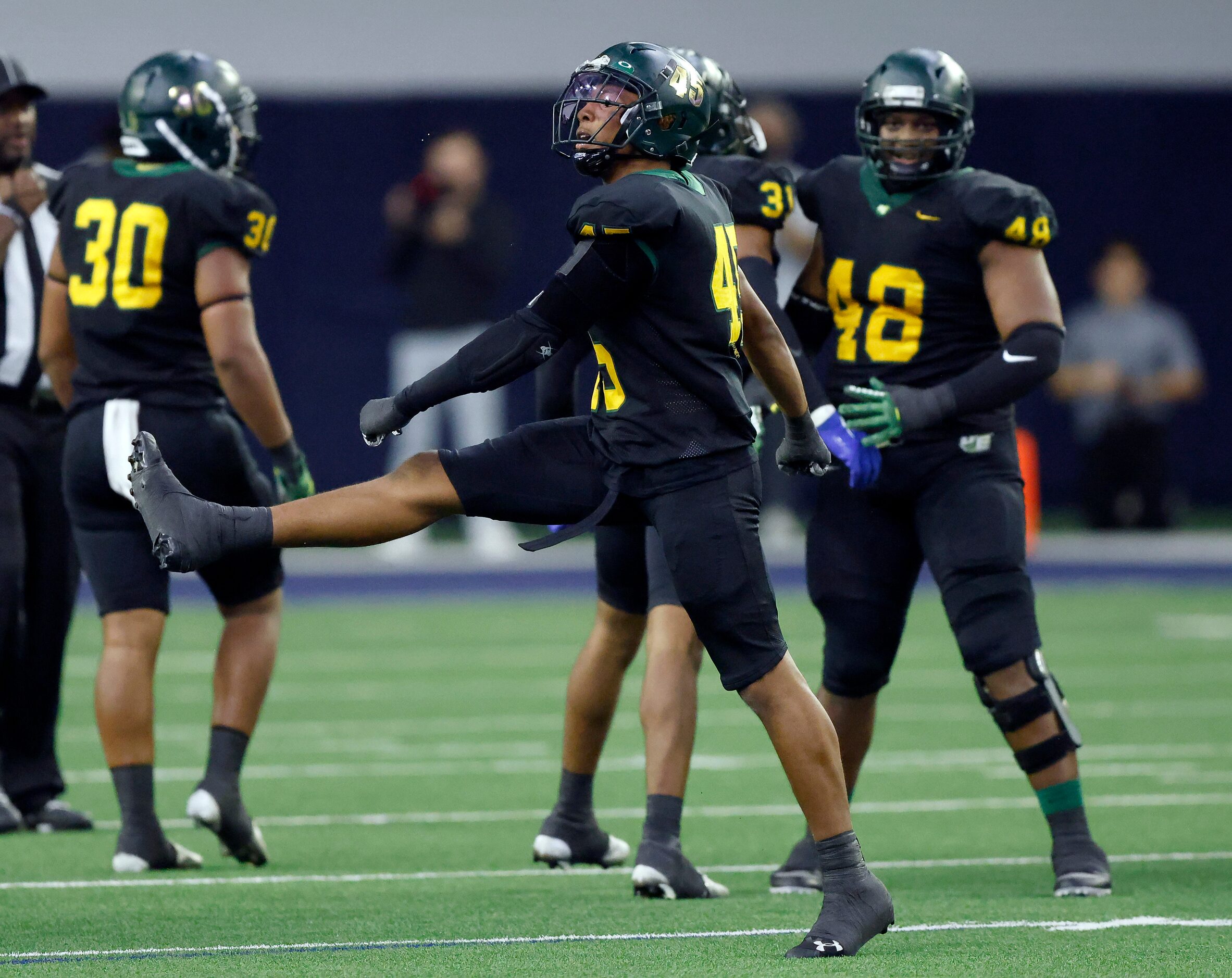 DeSoto defensive end Keylan Abrams (45) struts across the field after stopping Denton Guyer...