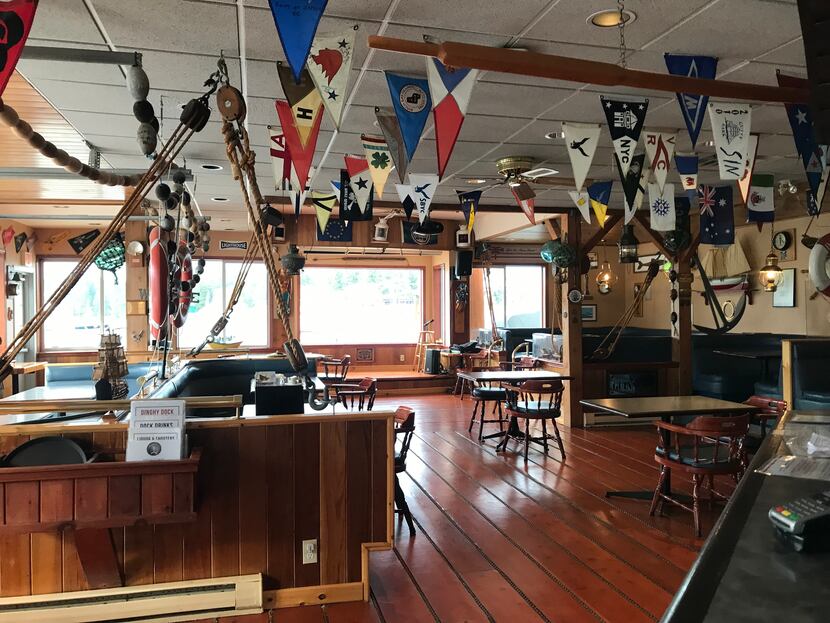 The interior of the Dinghy Dock Pub in Nanaimo, British Columbia has flags from different...