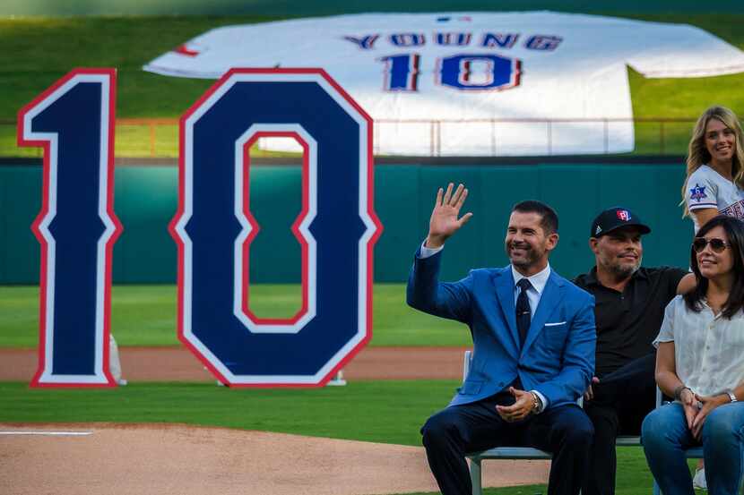 Michael Young waves to the crowd during ceremonies to retire Young's No. 10 before a game...