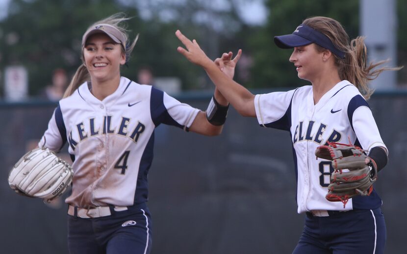 Keller outfielders Amanda Desario (4) and Brook Davis (8) celebrates Davis' catch in right...