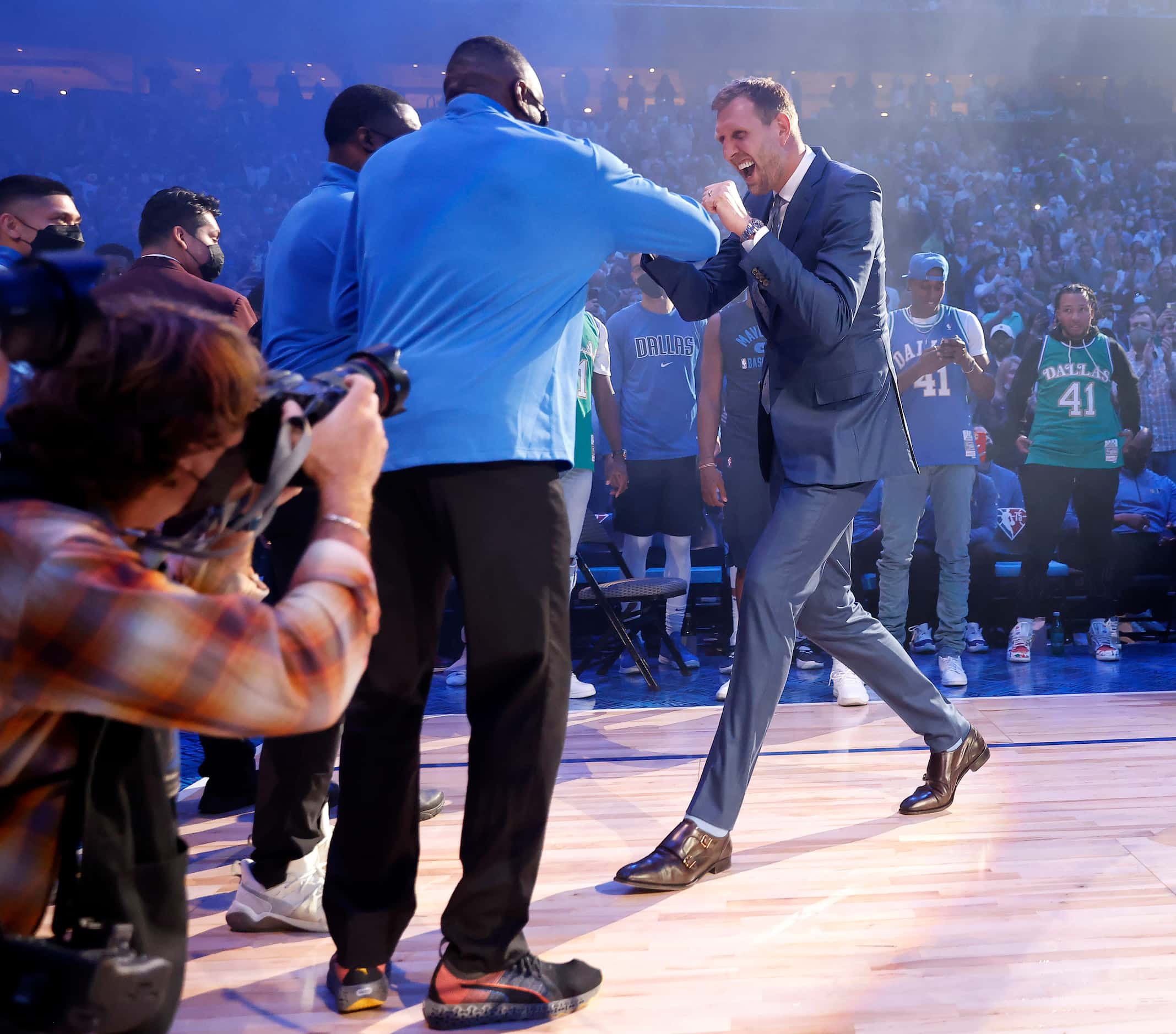 Former Dallas Mavericks All-Star Dirk Nowitzki gives fist bumps as he’s introduced to the...