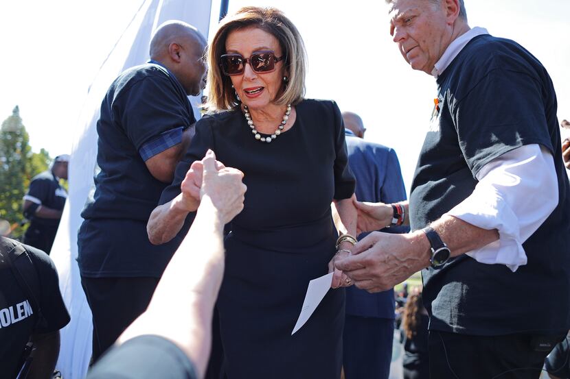 Speaker of the House Nancy Pelosi greets supporters and friends behind the stage during the...