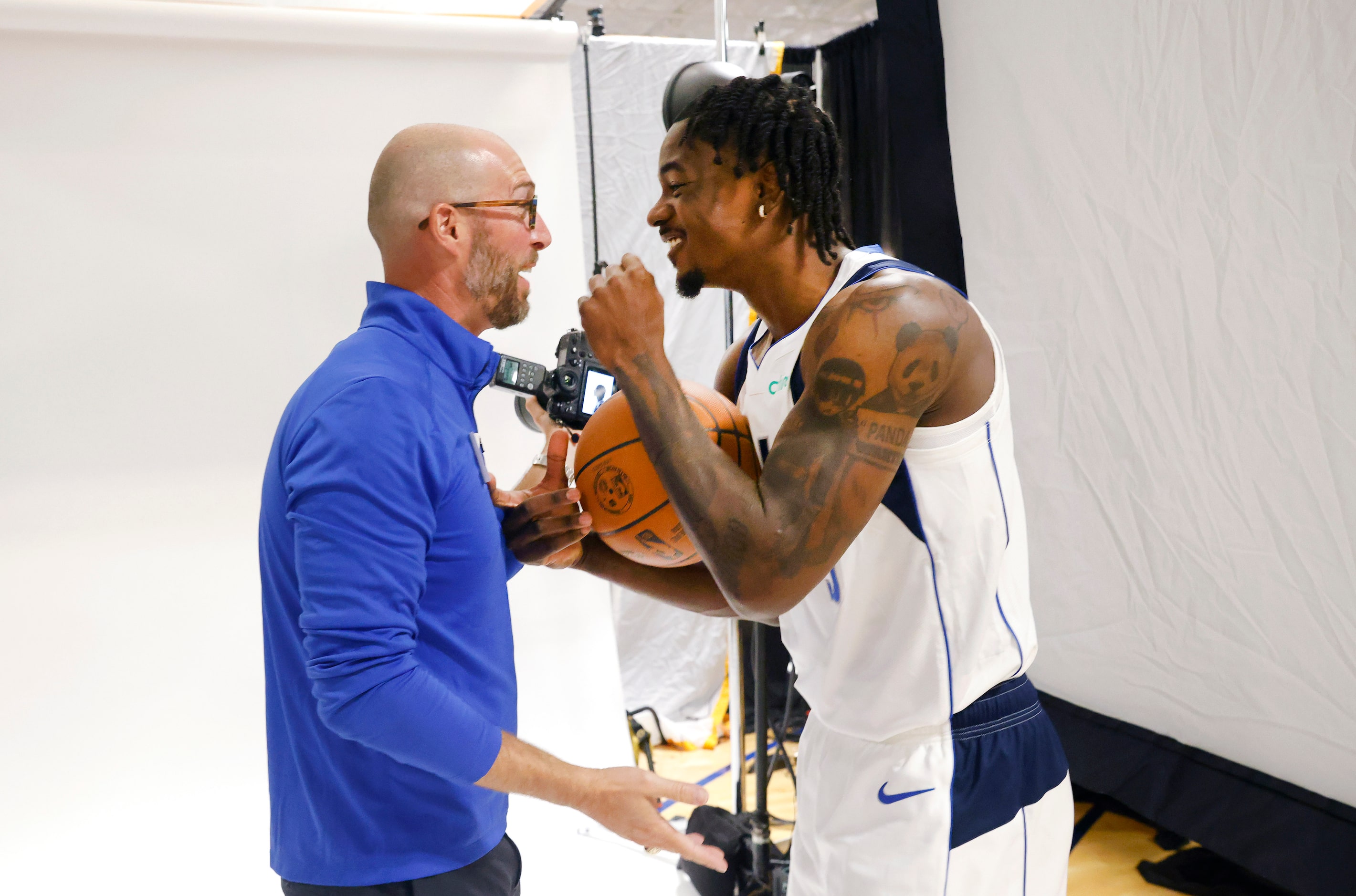 Dallas Mavericks rookie forward Emanuel Miller (right) reacts to the photos taken of him by...