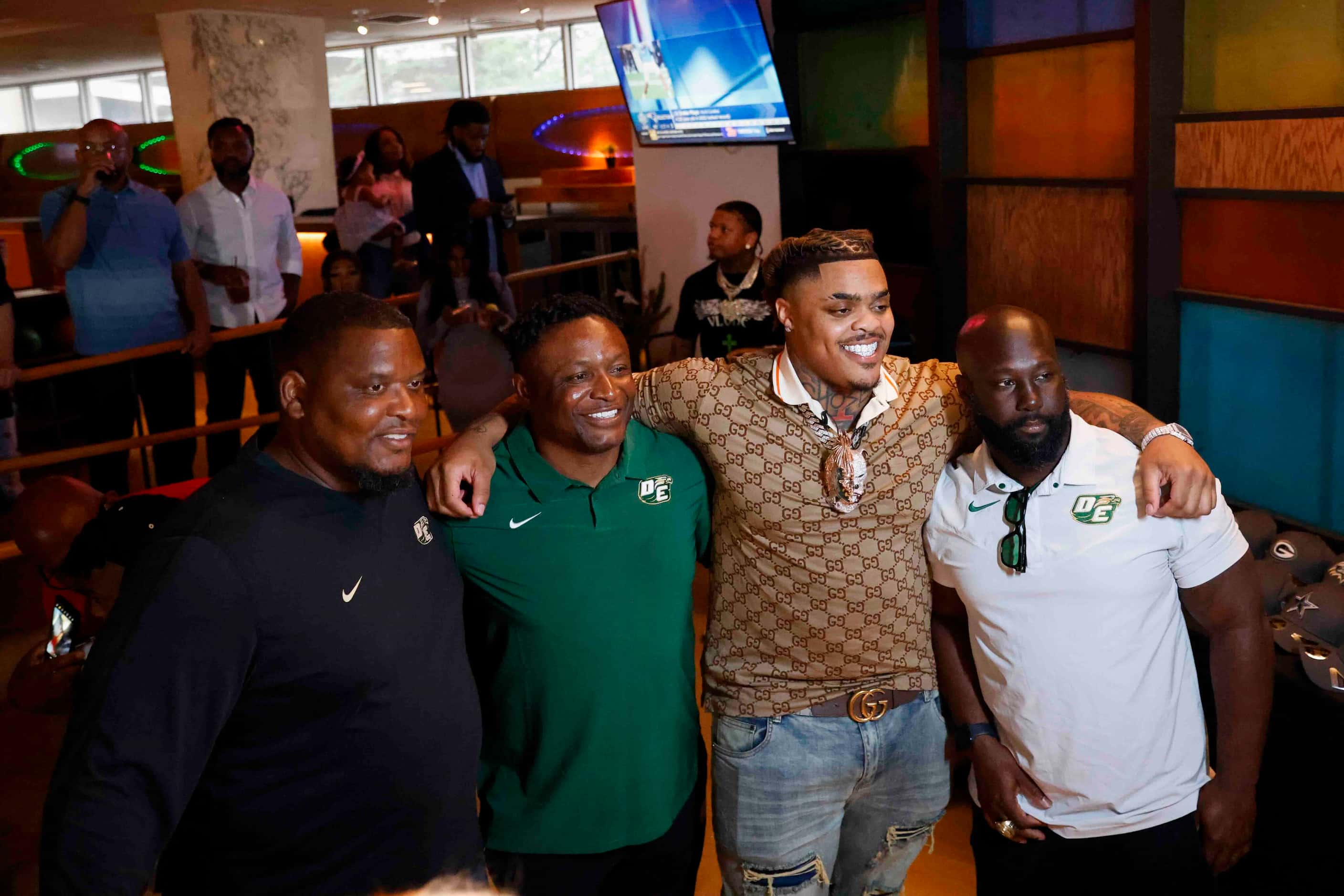 Texas defensive tackle Byron Murphy II, (center right), from DeSoto, takes a photo with...