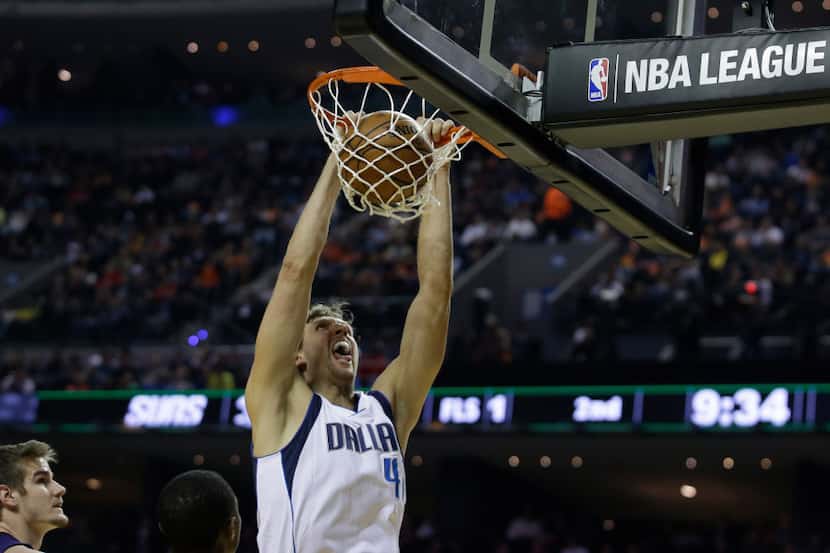 Dallas Mavericks Dirk Nowitzki scores against the Phoenix Suns in the first half of a...