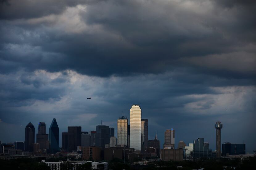 Thunderstorms clear downtown Dallas this evening ushering in north winds and cooler...