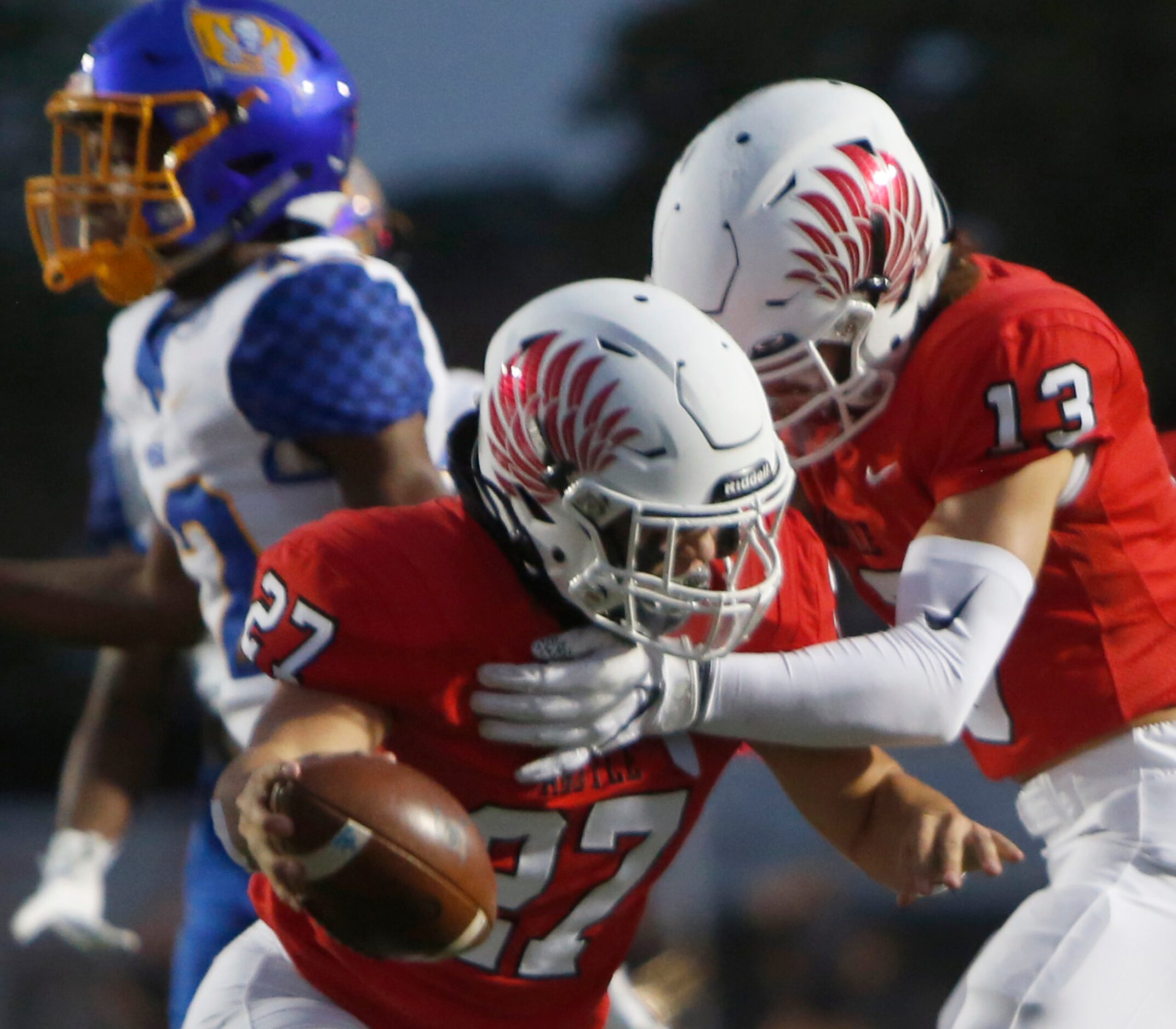 Argyle linebacker Logan May (27) celebrates with teammate Caleb Murdock (13) following his...