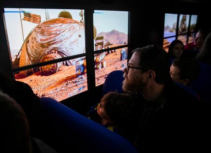 Christian Bennett, 5, and David Bennett and other passengers experience Lockheed Martin's...