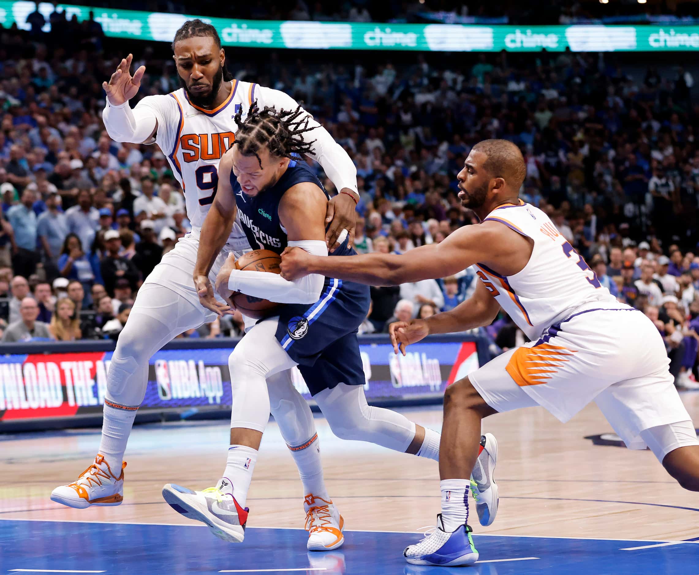 Dallas Mavericks guard Jalen Brunson (13) is fouled by Phoenix Suns guard Chris Paul (3) as...