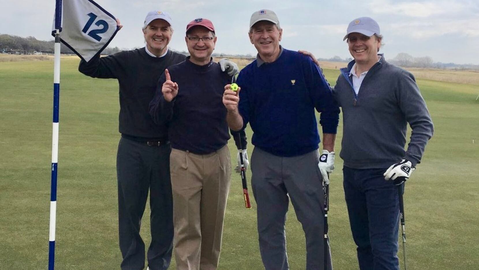 George W Bush celebrates his hole in one on 12 at Trinity Forest.