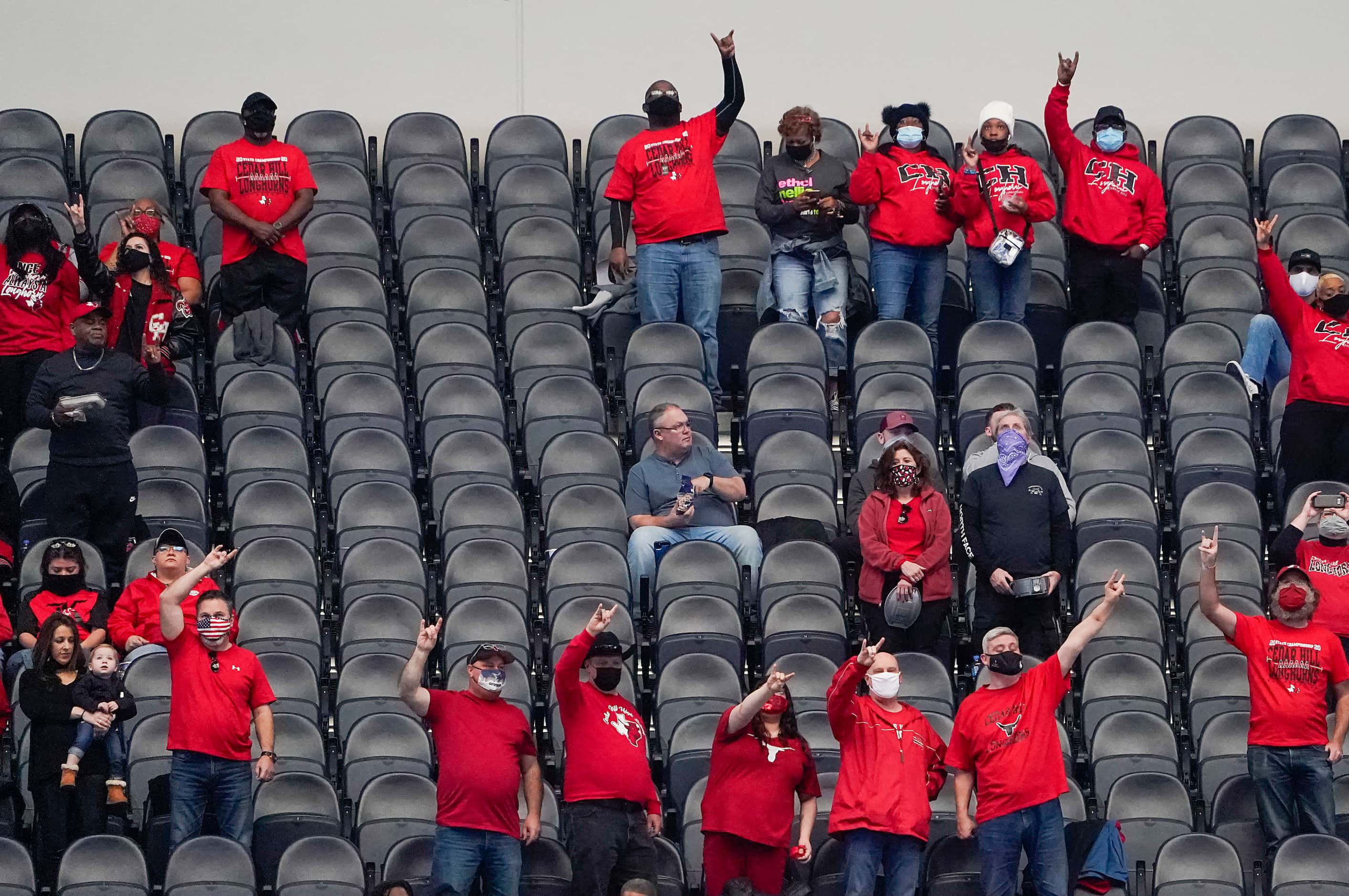 Cedar Hill fans stand for their school song before the Class 6A Division II state football...