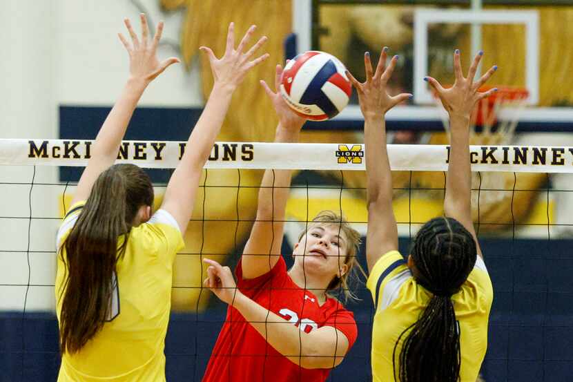 McKinney Boyd’s Sasha Purdin (20) hits a shot between McKinney’s Olivia Cohee (left) and...