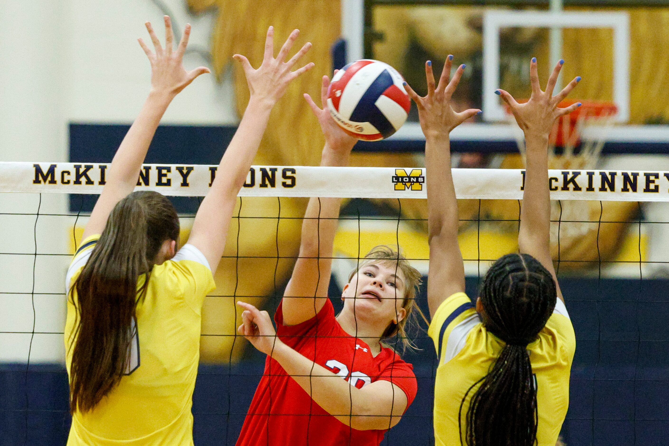 McKinney Boyd’s Sasha Purdin (20) hits a shot between McKinney’s Olivia Cohee (left) an...