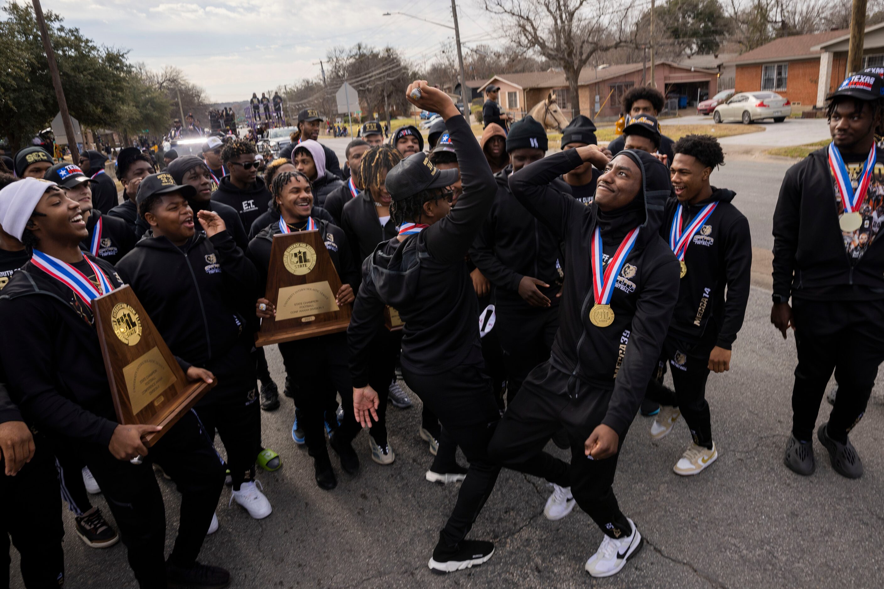 The South Oak Cliff Golden Bears defensive back David “Davo” Spruiells (center left) and...