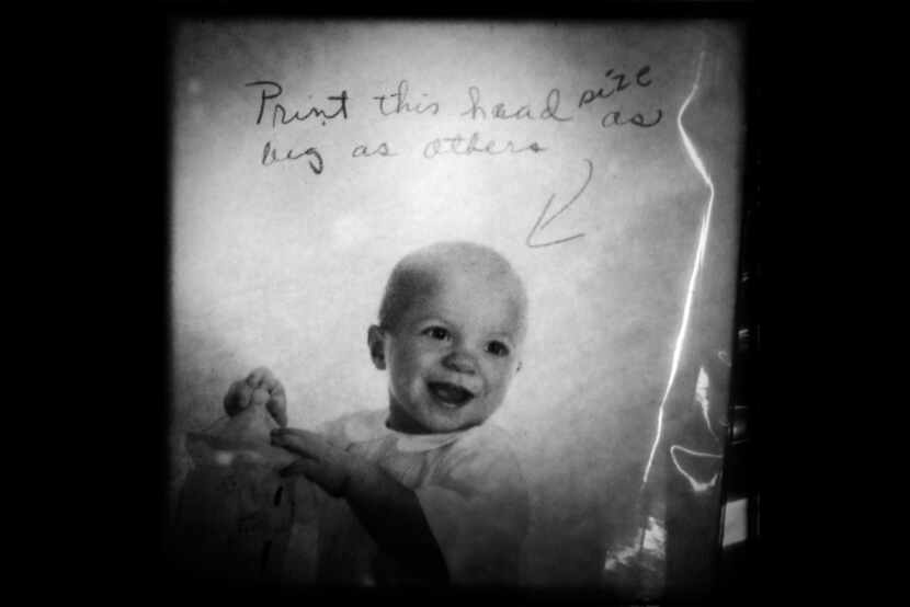 Printing instructions are written on a portrait of a child.