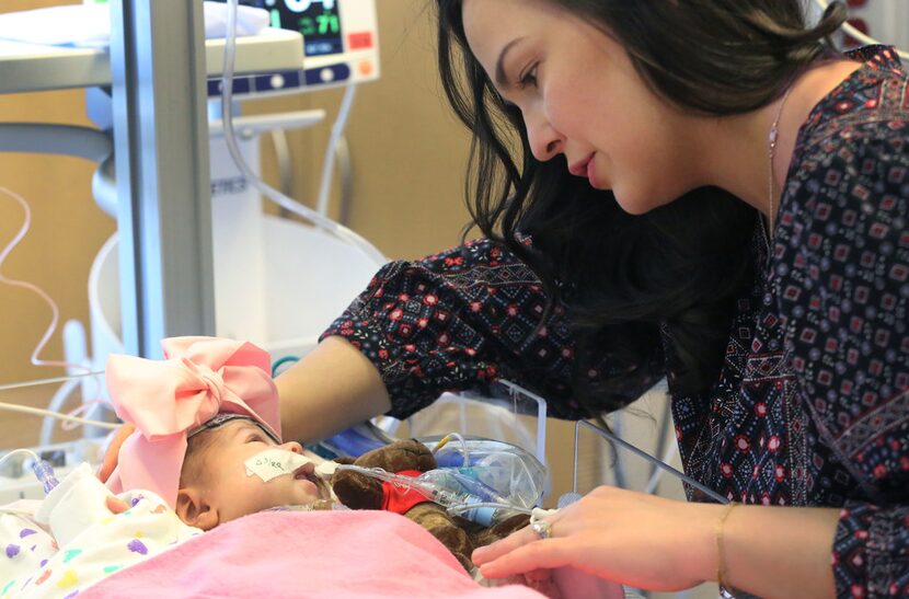 Jacqueline Nortman spends a tender moment with her daughter Olivia. Nortman is a pediatrician. 