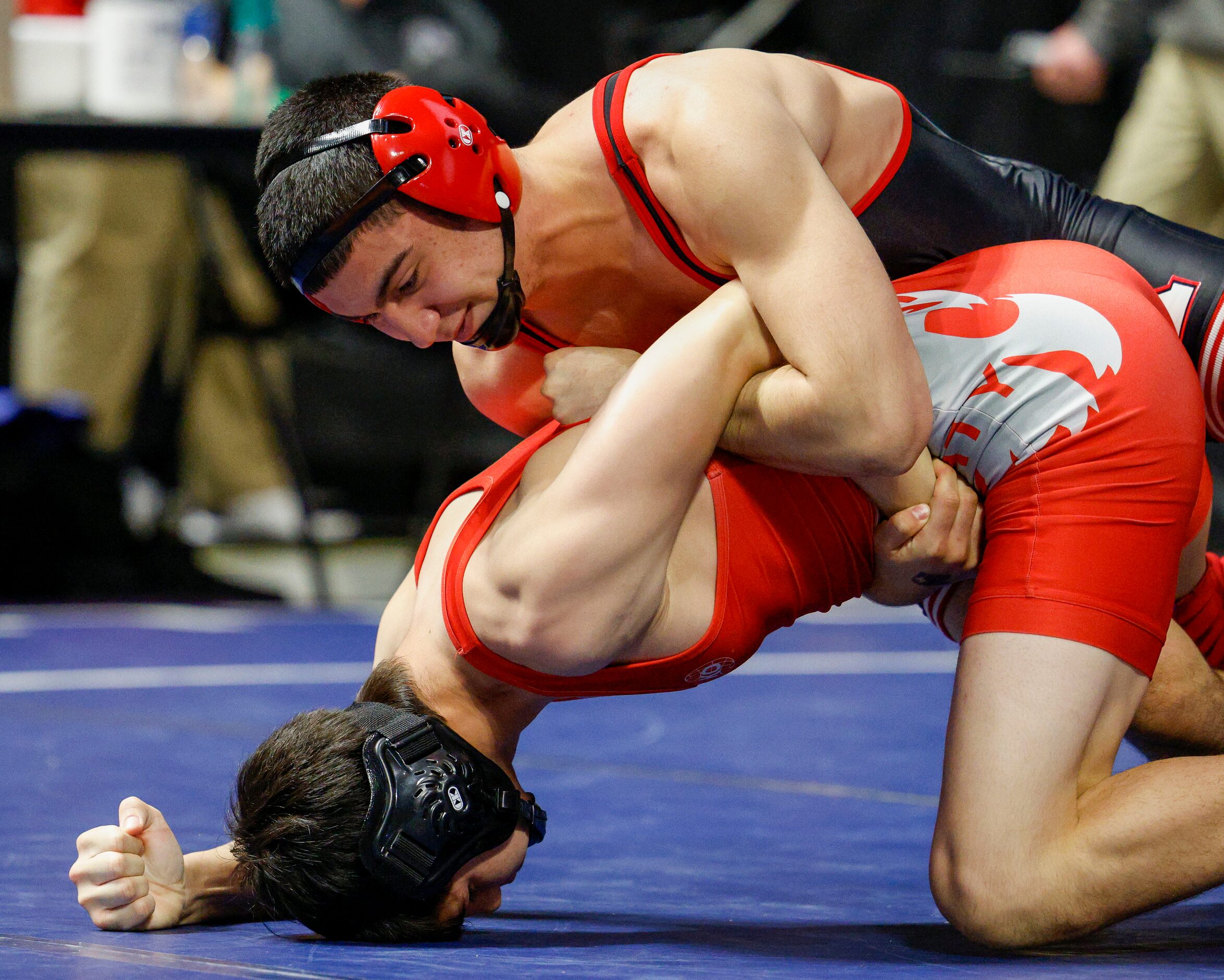 Connor Timmons of Katy (left) wrestles Kade Moore of Allen during a quarterfinal match of...