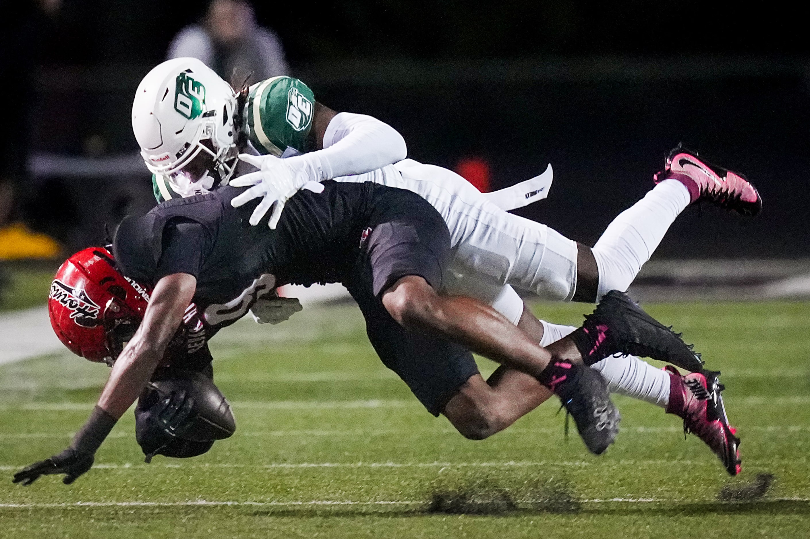 Cedar Hill tight end Dillen Johnson (9) is brought down by DeSoto defensive back Sael Reyes...