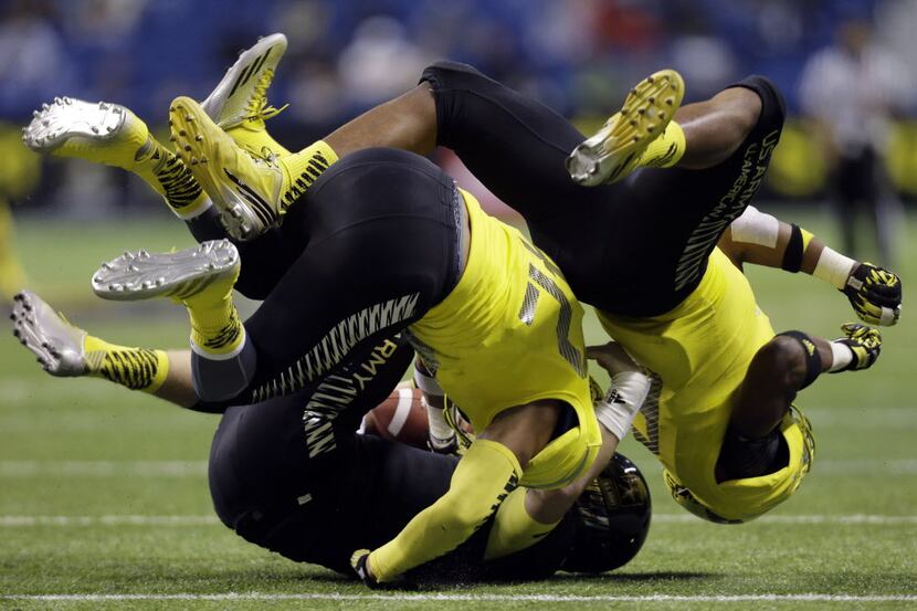 U.S. Army All-American East's Jacob Park, left, is dropped by U.S. Army All-American West's...
