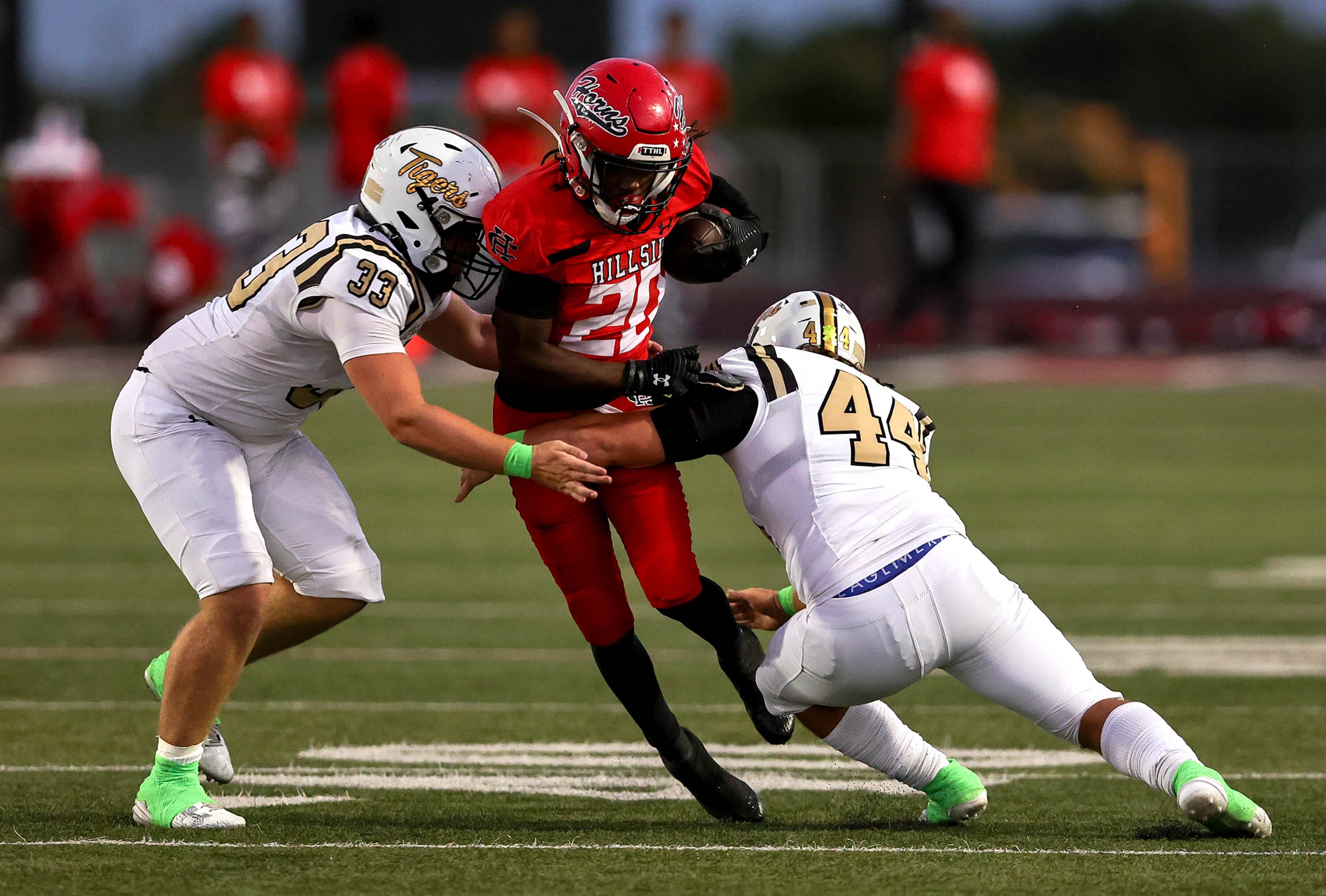 Cedar Hill running back Cededrick Castleberry (20) tries to get past Mansfield linebacker...