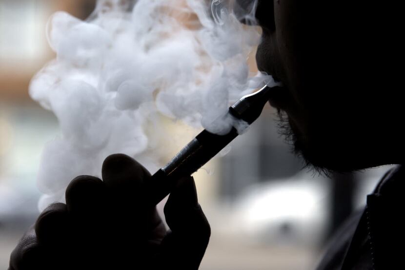 In this April 23, 2014 photo, a man smokes an electronic cigarette in Chicago. On Tuesday,...