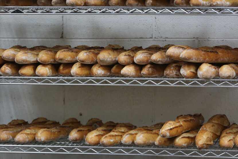 Freshly-baked baguettes sit on a shelf at the Empire Baking Company on East University Drive...