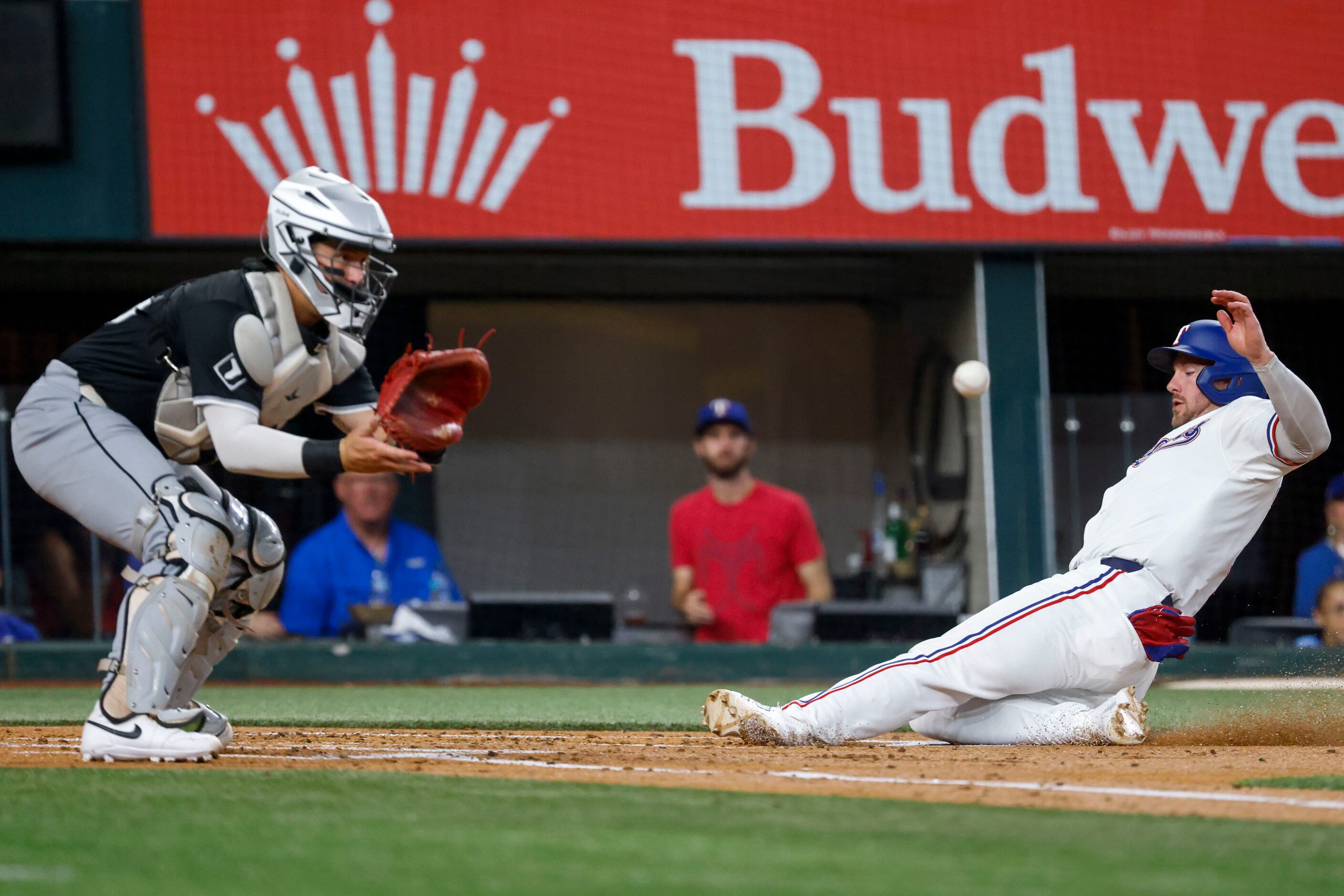 Texas Rangers' Robbie Grossman (right) scores on a single by Adolis Garcia (not in the...