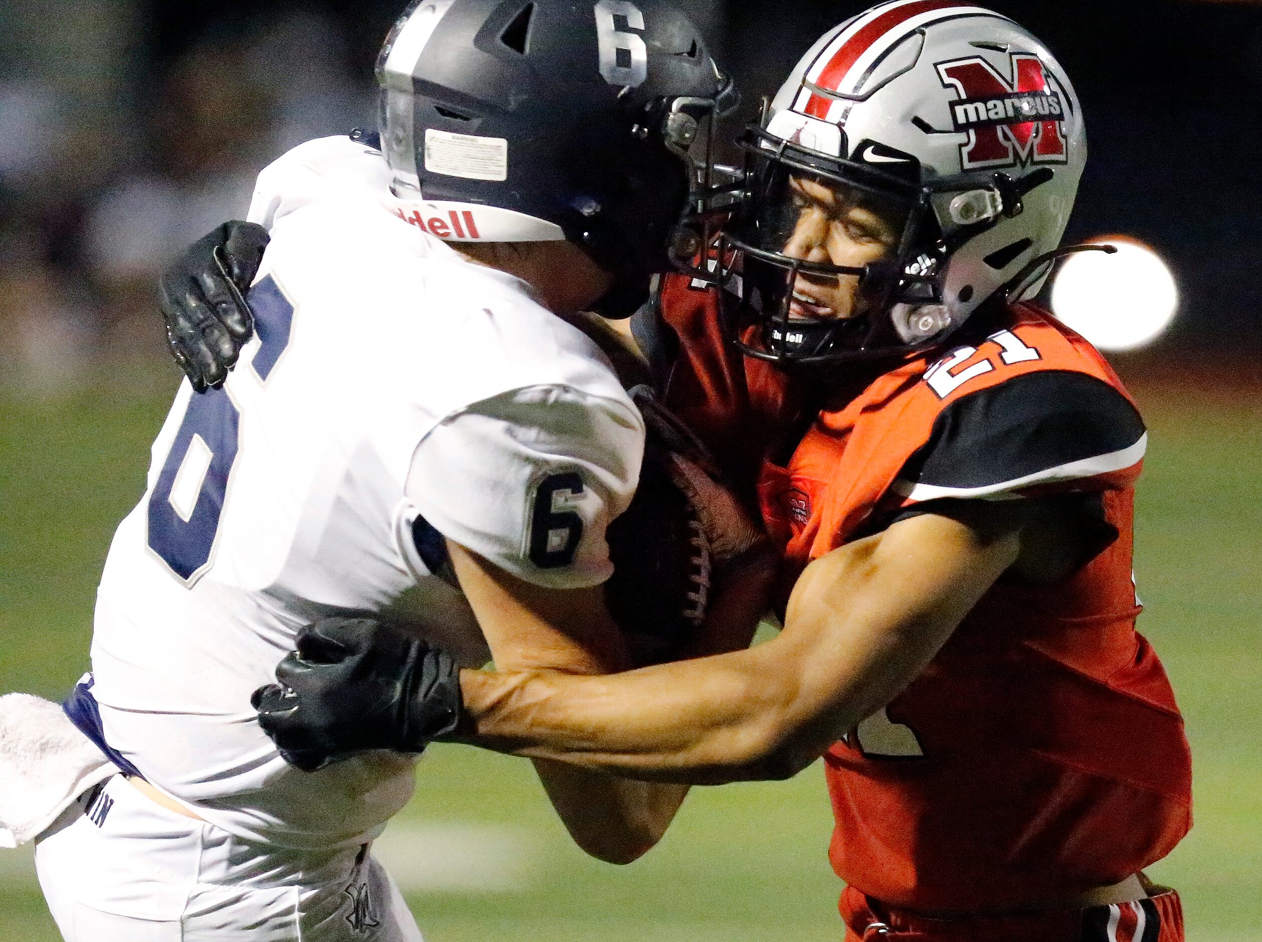 Flower Mound Marcus High School cornerback Zach Morris (21) hits Flower Mound High School...