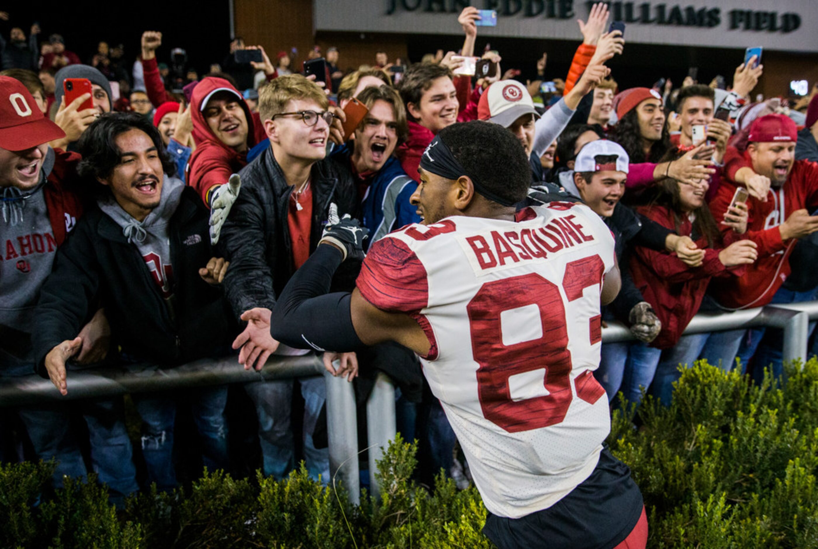 Oklahoma Sooners wide receiver Nick Basquine (83) celebrates with fans after a 34-31 win...