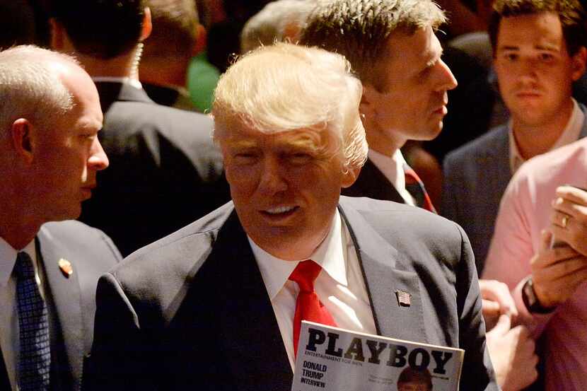 Republican presidential nominee Donald Trump shows his photo on the cover of a Playboy...
