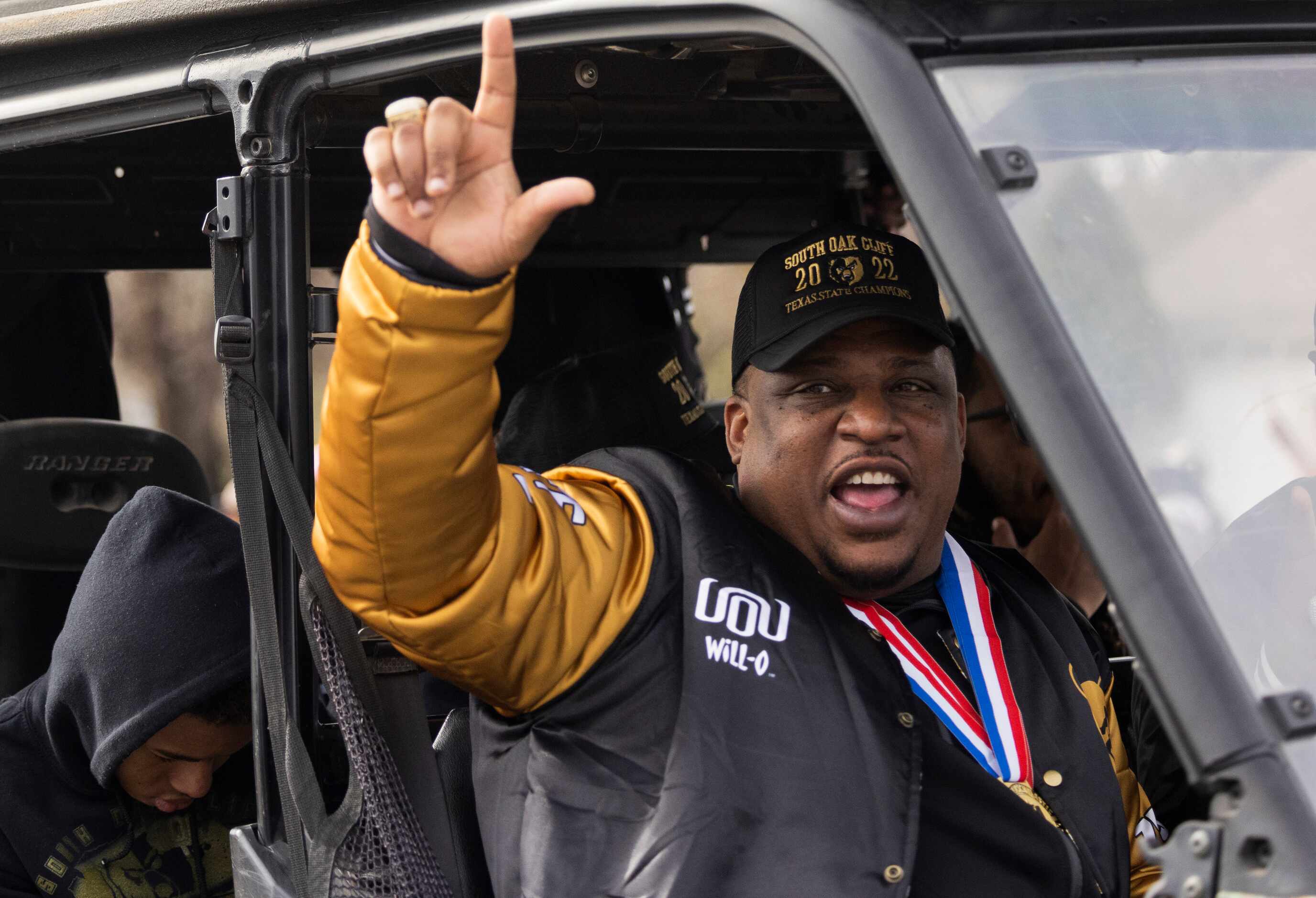 The South Oak Cliff Golden Bears coach Jason Todd motions to the crowd during a parade for...