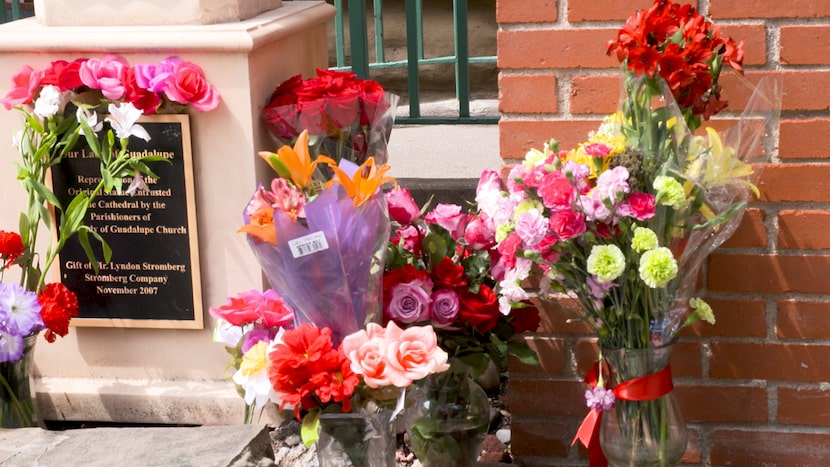 Flowers were placed Sunday at the base of the Our Lady of Guadalupe statue at the Cathedral...