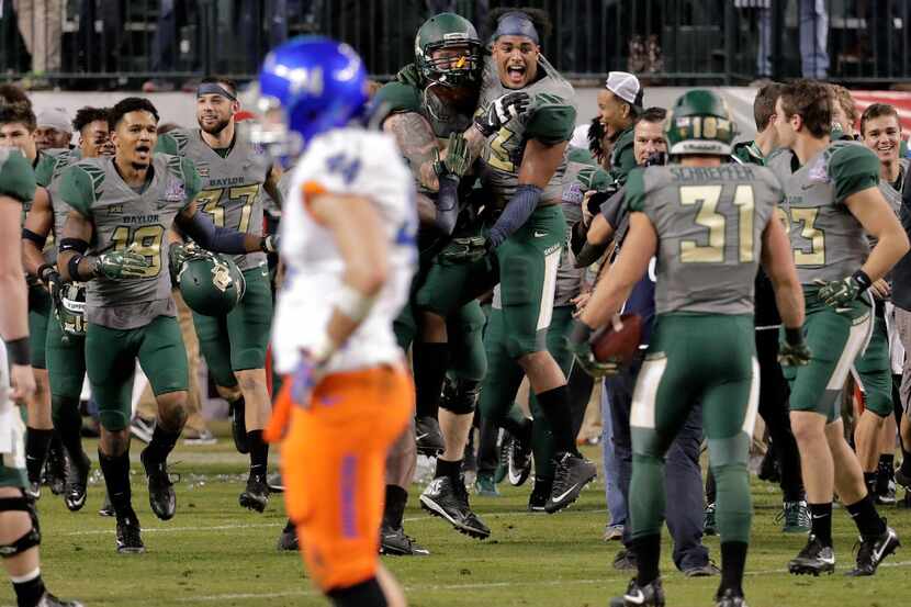 Baylor players run on the field as time expires in the second half of the Cactus Bowl NCAA...