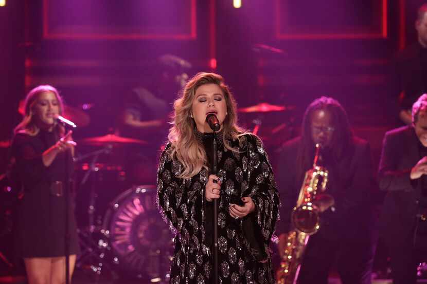 Singer Kelly Clarkson, shown performing "Whole Lotta Woman" on Oct. 31, 2017, sings...