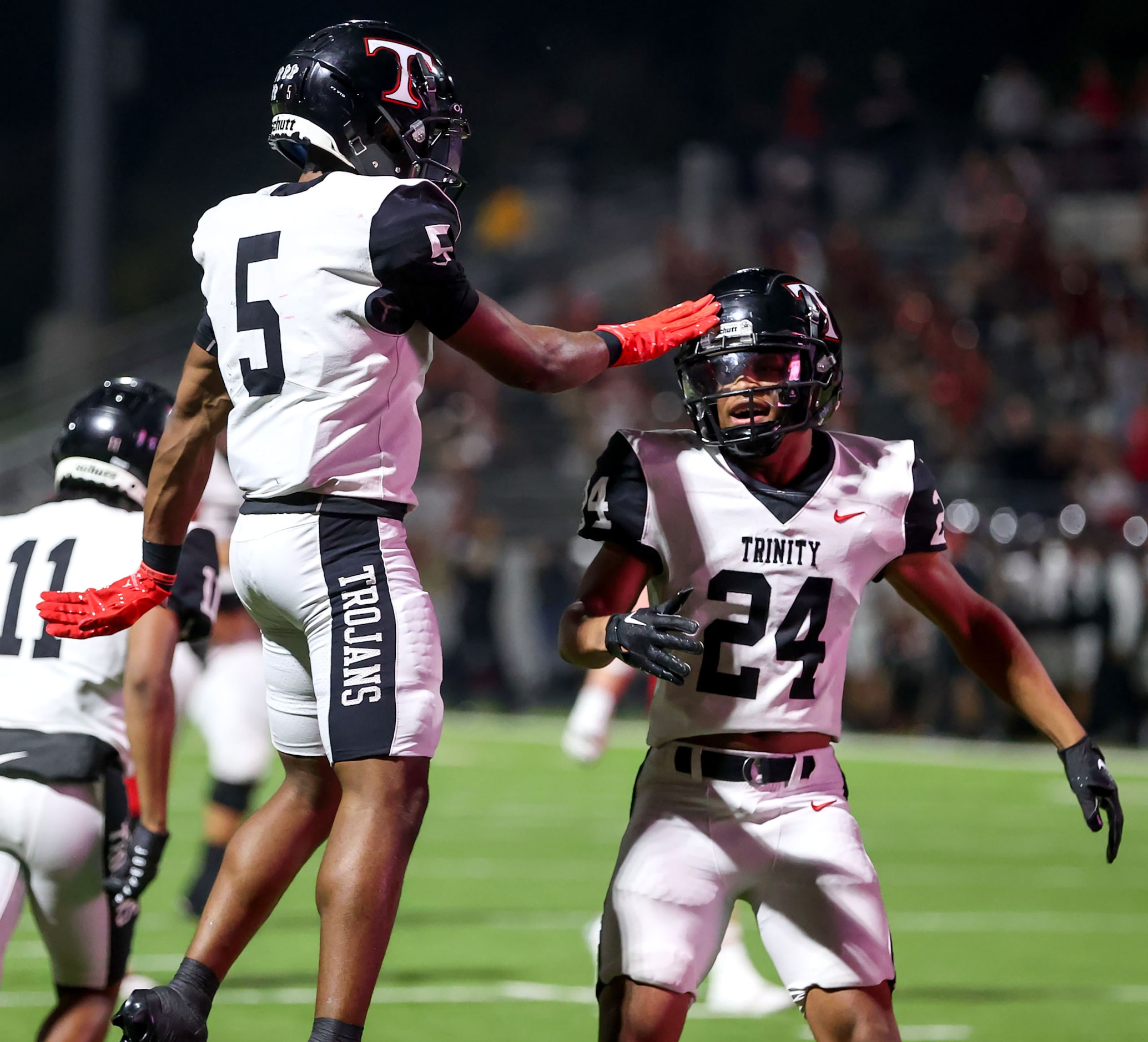 Trinity wide receiver Ethan Wright (5) celebrates with running back JT Harris (24) after...