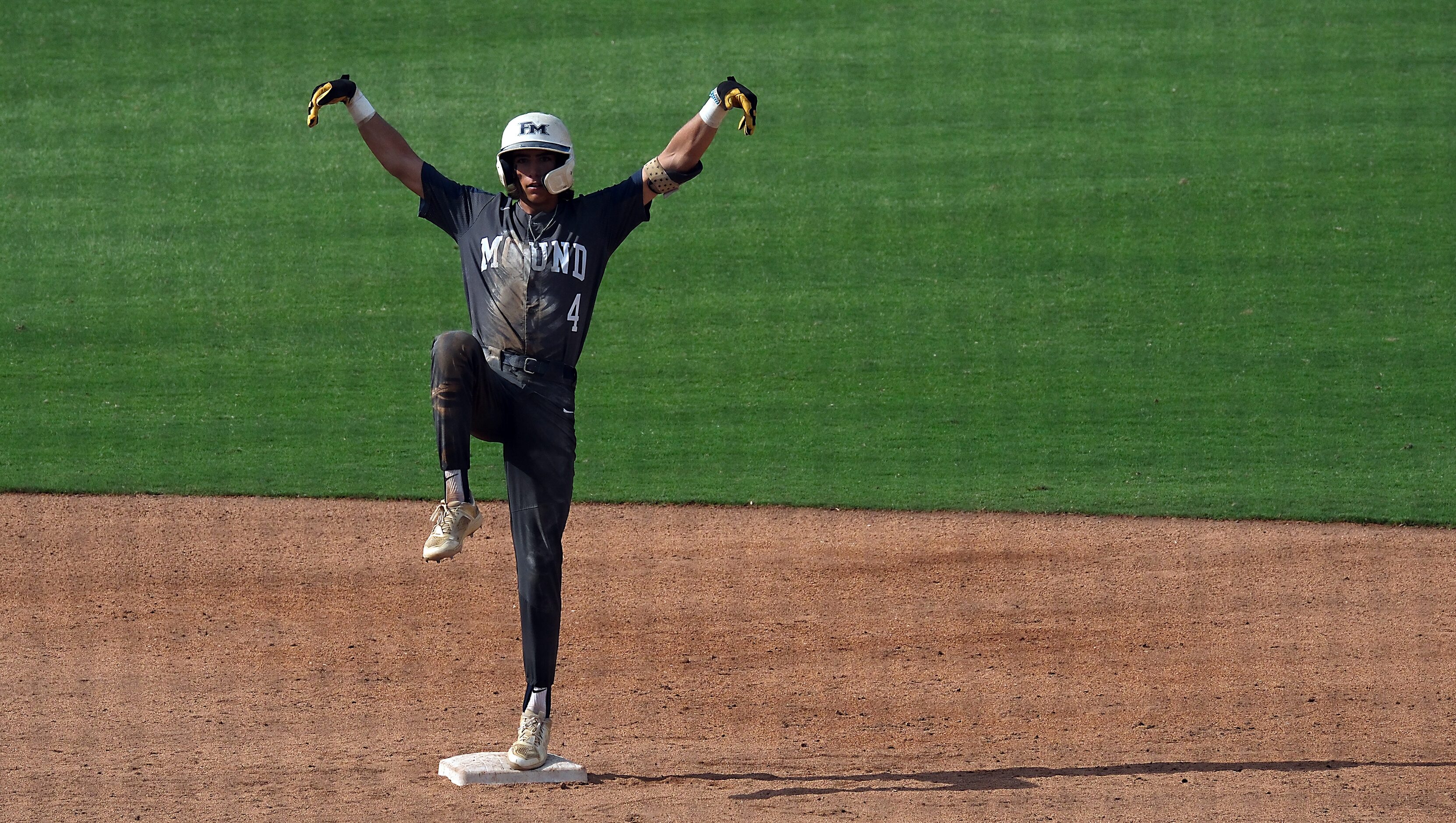 Flower Mound Ryder McDaniel, (4), strikes a pose on the second base bag after hitting a...