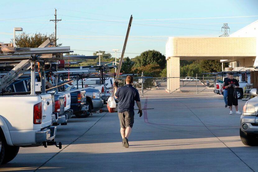 
A Garage Door Services repairman carried a part through the company’s parking lot in...