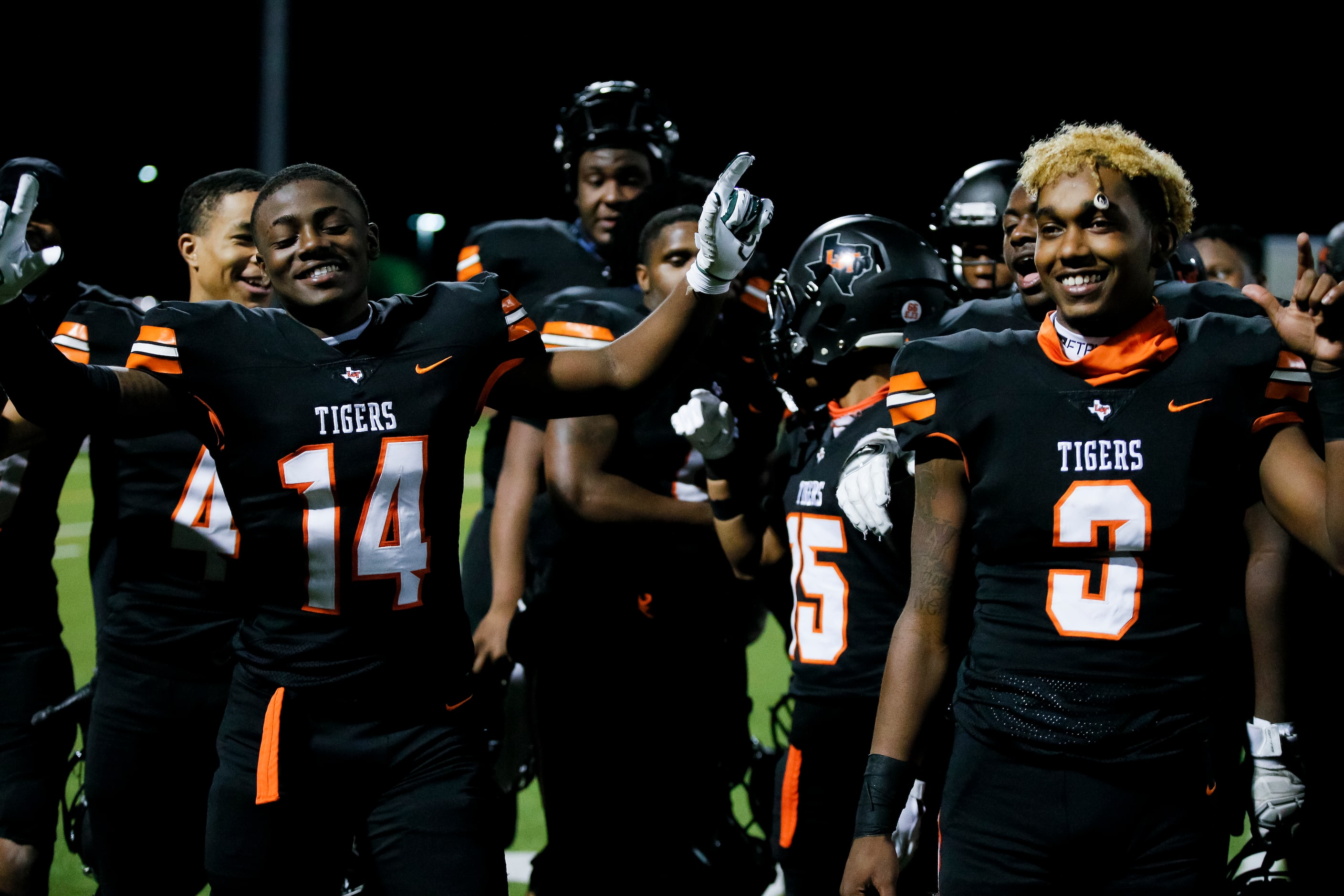 Lancaster senior Elijah Conley (14) and junior quarterback Glenn Rice Jr. (3) celebrate a...