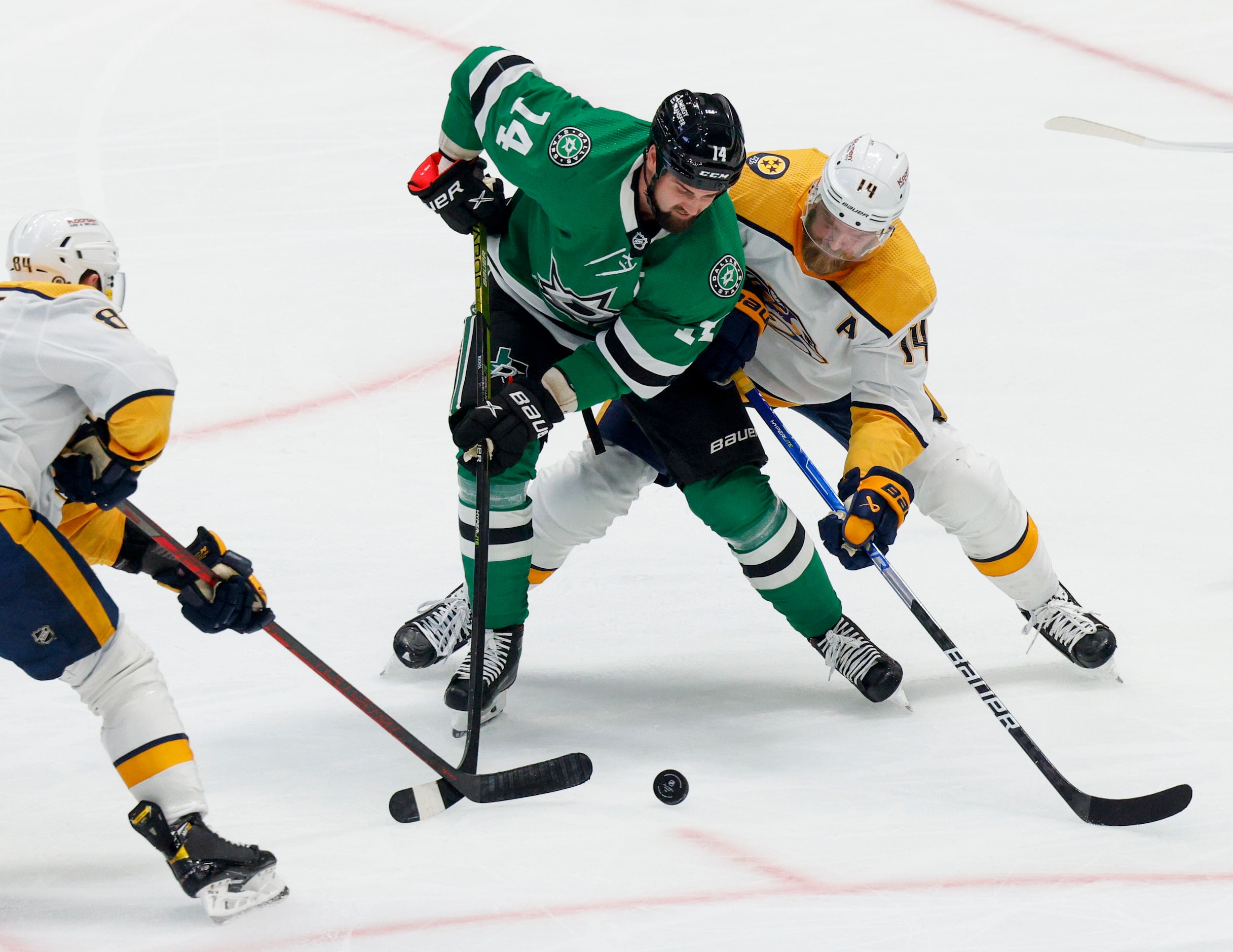 Dallas Stars left wing Jamie Benn (14) fights for a loose puck with Nashville Predators left...