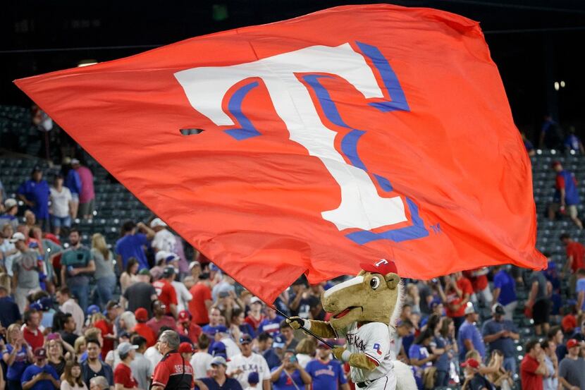 The Rangers Captain mascot waves a Texas Rangers flag after a victory over the Tampa Bay...