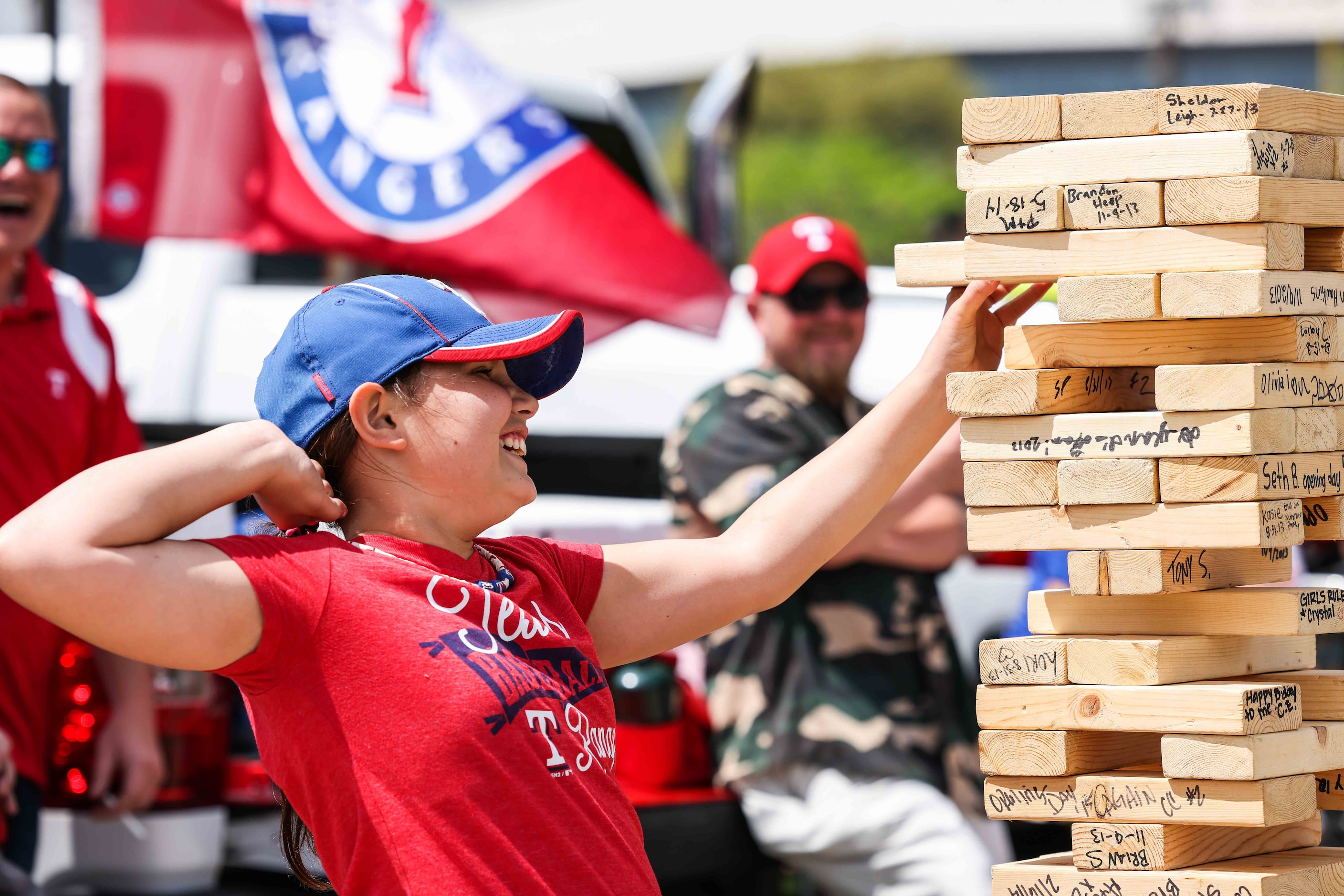 Skylar Watts, 11, plays Jenga outside the Globe Life Field before the game between Texas...