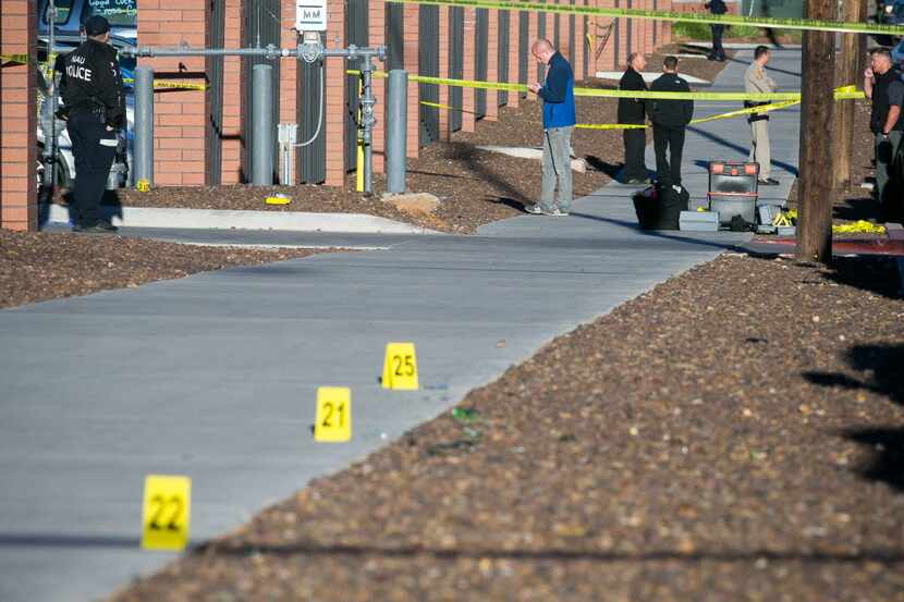  Police officers investigate a shooting at Northern Arizona University campus in Flagstaff,...