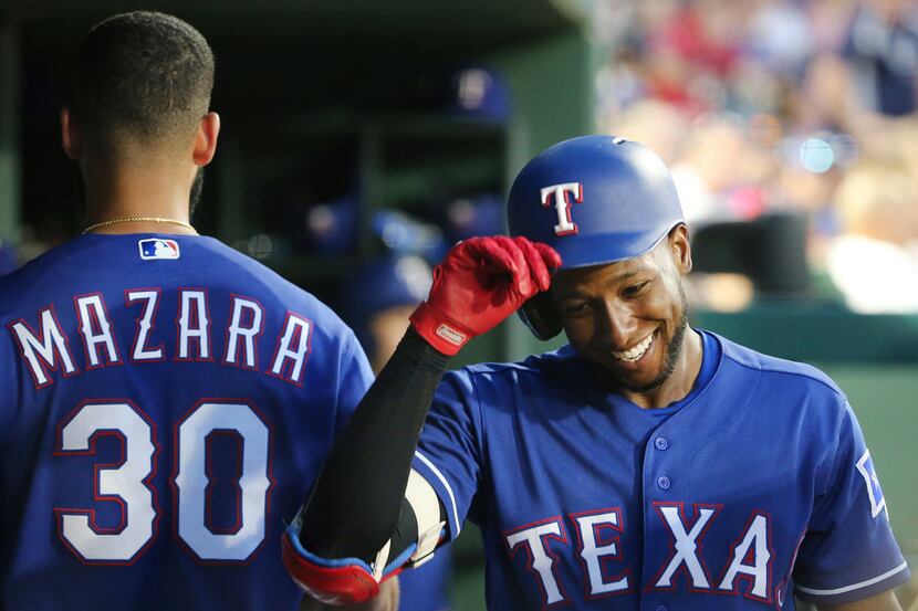 Texas Rangers shortstop Jurickson Profar (19) celebrates after hitting a home run to make...