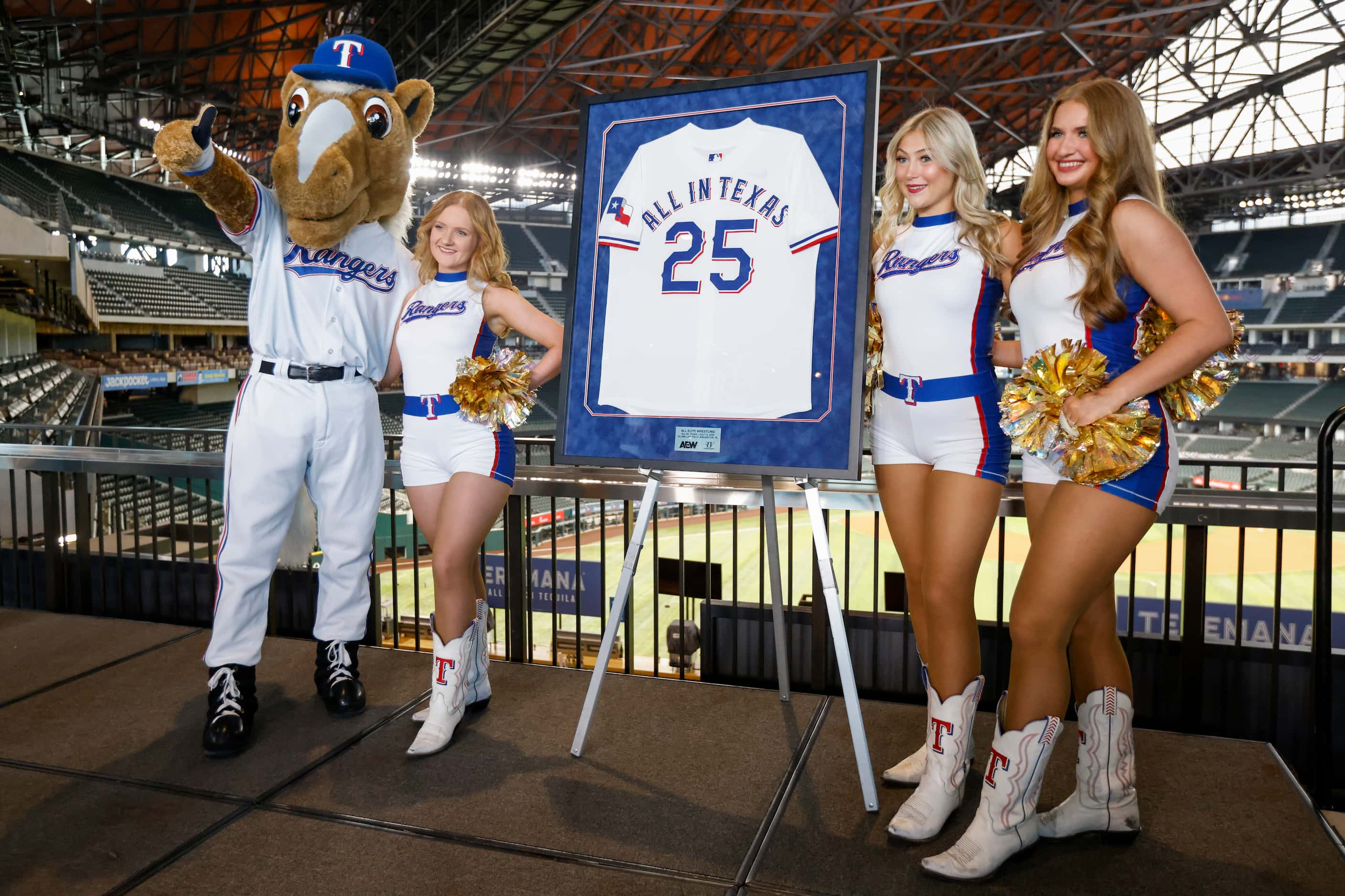 Texas Rangers mascot Capitan poses for photos with members of Rangers Six Shooters and a...