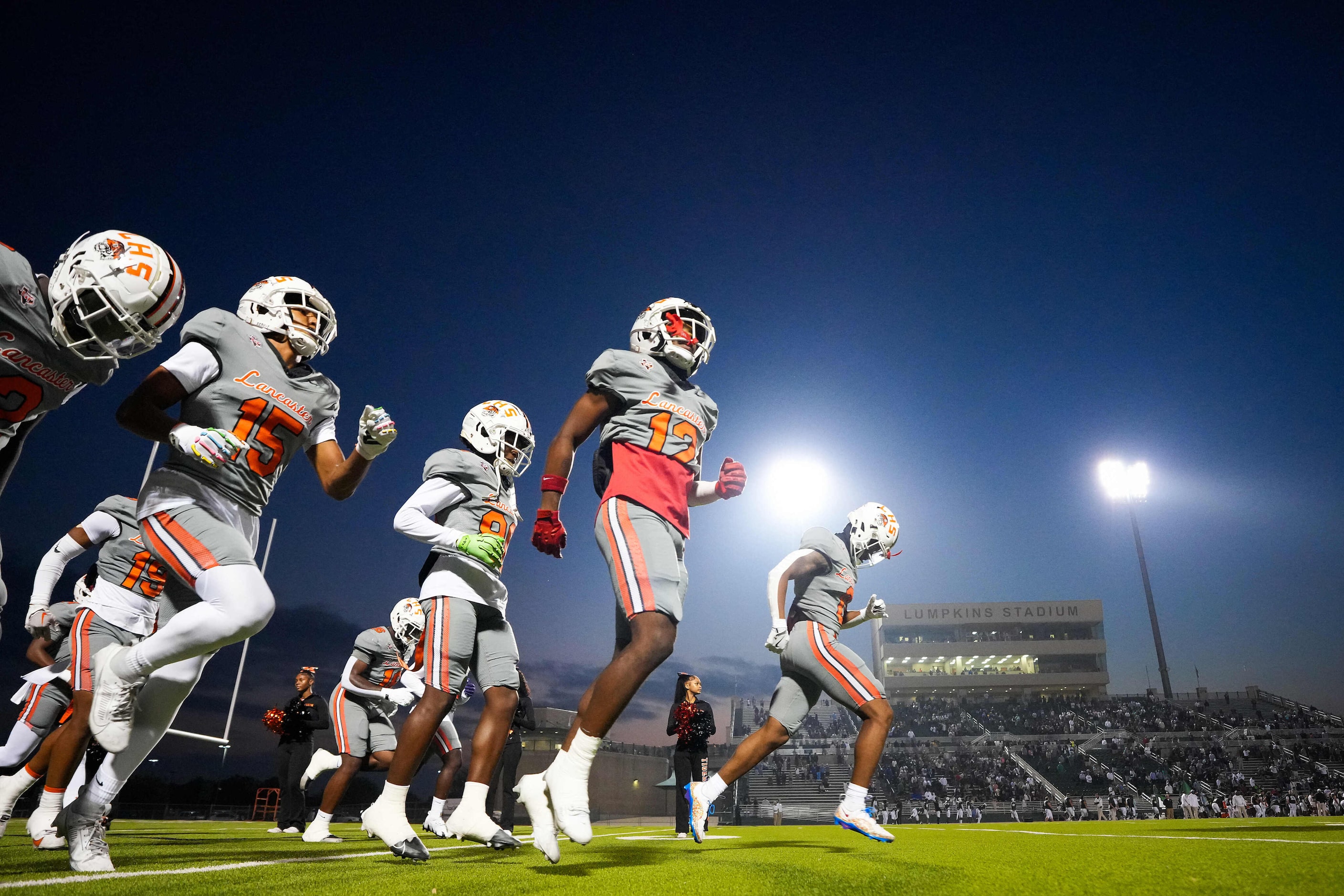 Lancaster wide receiver Sir'Eric Scarbough (12) takes the field with teammates before a...