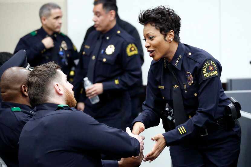 Dallas Police Chief Renee Hall congratulates her police officers who were recognized before...