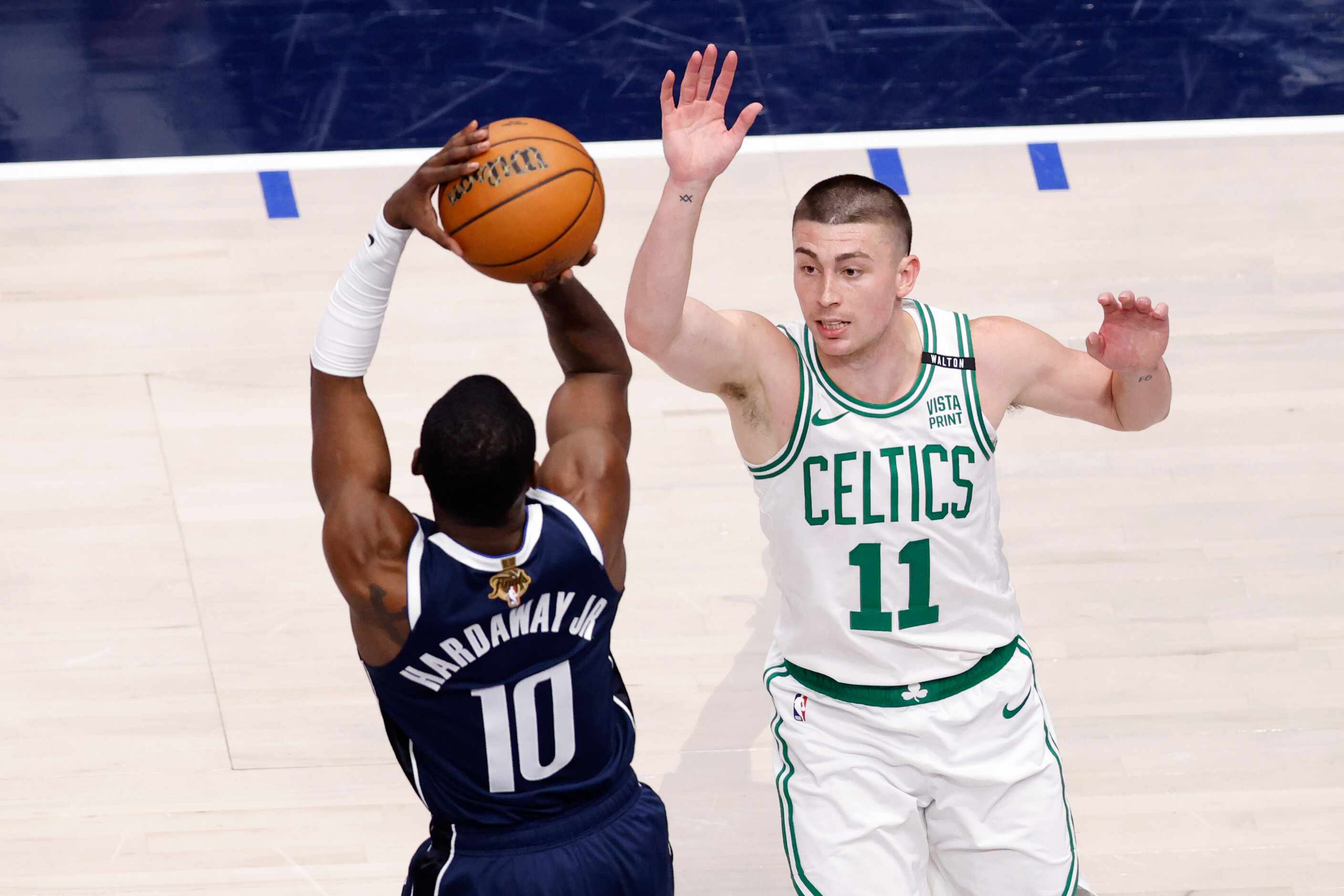 Dallas Mavericks forward Tim Hardaway Jr. (10) shoots a three-pointer over Boston Celtics...
