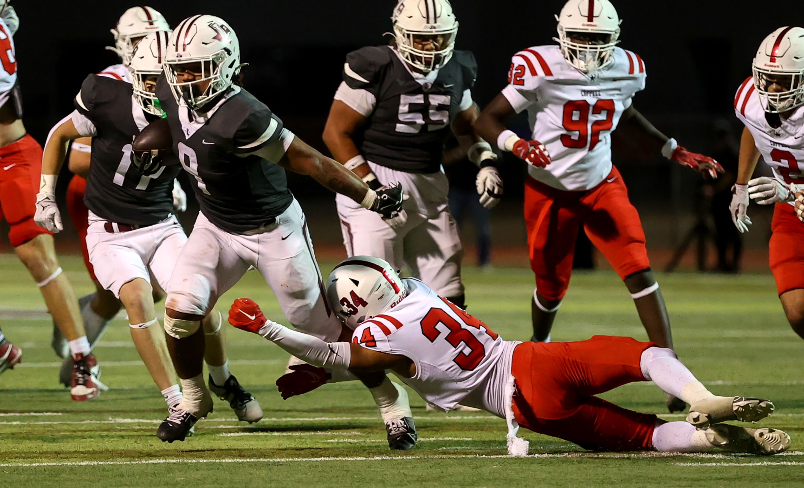 Lewisville running back Tenel Hill (9) tries to break a tackle from Coppell safety Tyrell...